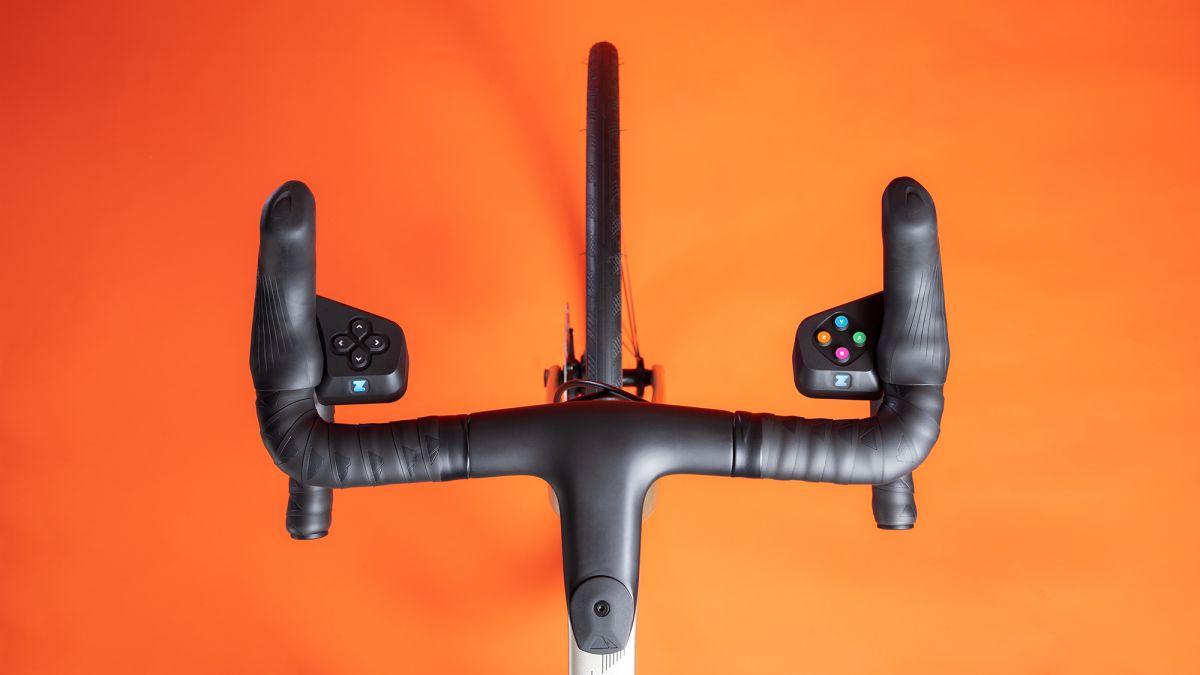 Zwift Play controllers mounted on a bike against a studio backdrop