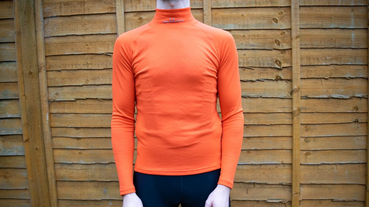 Tom wearing an orange Galibier Barrier base layer, which is form fitting with a high collar