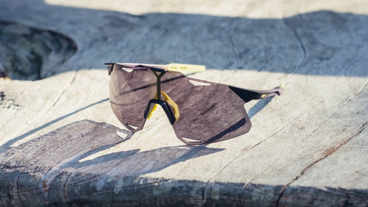 A pair of 100% Hypercraft cycling glasses on a wooden bench