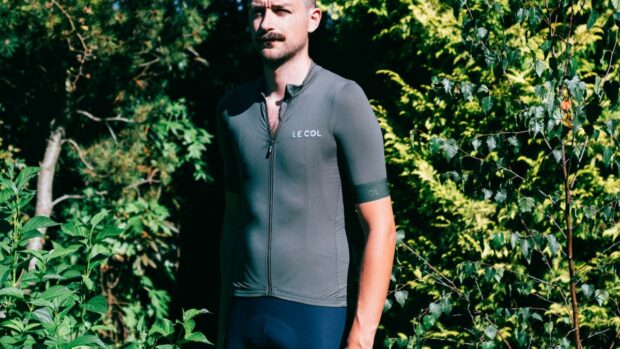 A white man with a moustache wears the sage green le col pro jersey II