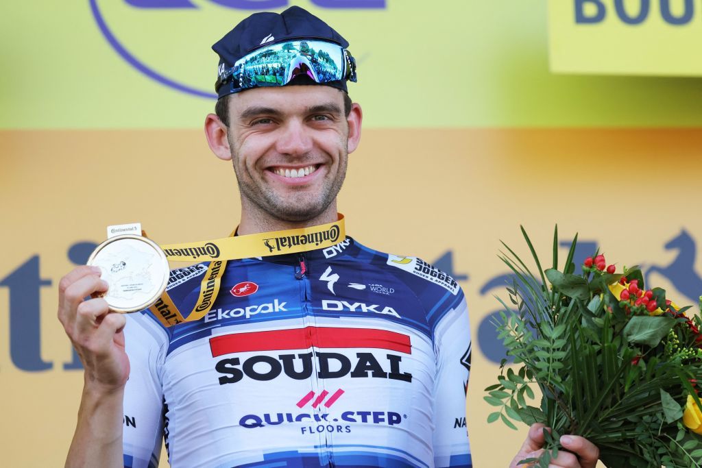Soudal QuickSteps Danish rider Kasper Asgreen celebrates on the podium after winning the 18th stage of the 110th edition of the Tour de France cycling race 184 km between Moutiers and BourgenBresse in the French Alps on July 20 2023 Photo by Thomas SAMSON AFP Photo by THOMAS SAMSONAFP via Getty Images