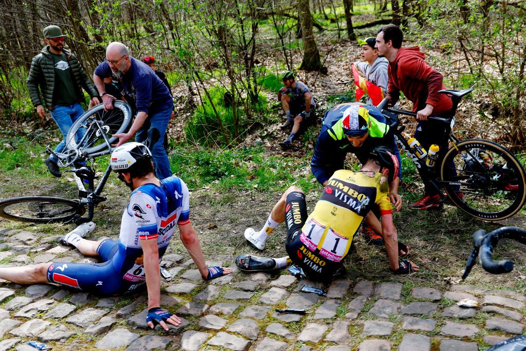 ROUBAIX FRANCE APRIL 09 EDITORS NOTE Image depicts graphic content LR Kasper Asgreen of Denmark and Team Soudal Quick Step and Dylan Van Baarle of The Netherlands and Team JumboVisma after being involved in a crash during the 120th ParisRoubaix 2023 Mens Elite a 2566km one day race from Compigne to Roubaix on UCIWT April 09 2023 in Roubaix France Photo by Etienne Garnier PoolGetty Images