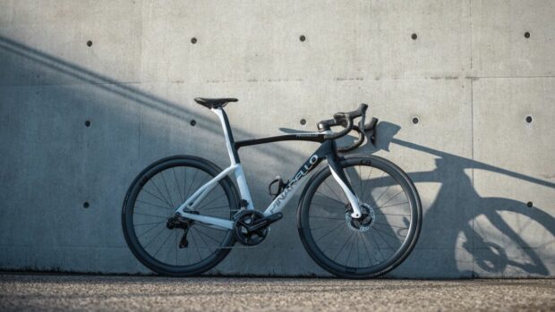 A white and black pinarello F9 against a concrete wall