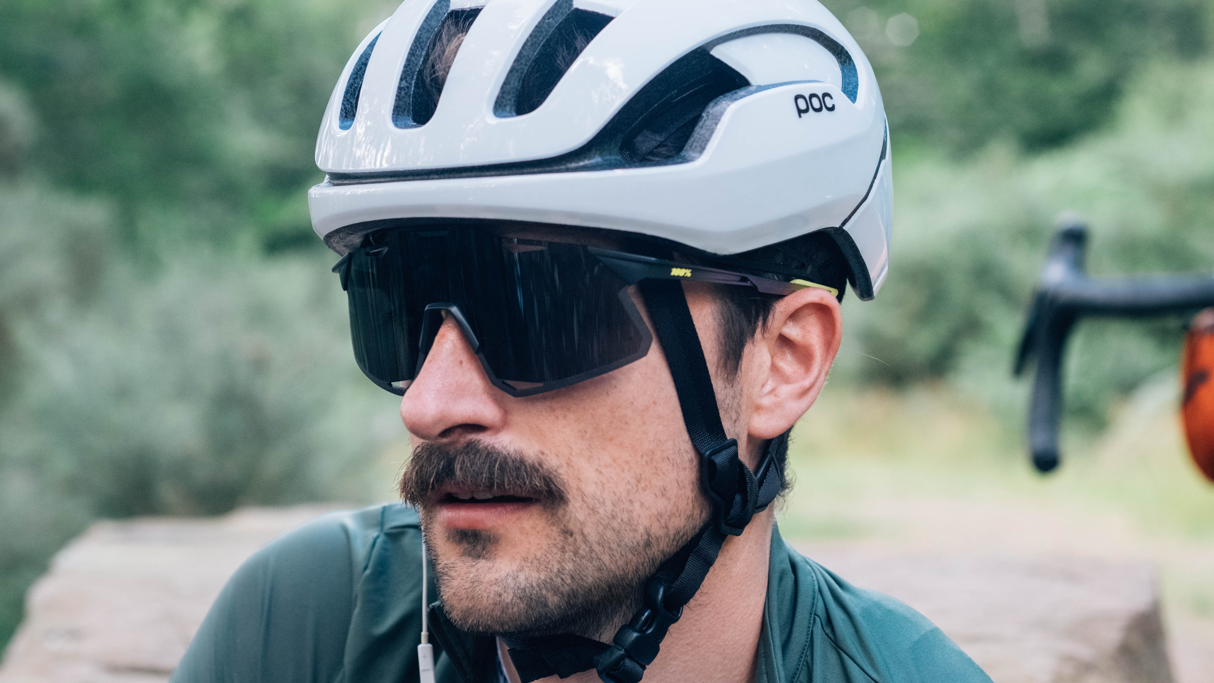 Un homme blanc à moustache porte une paire de lunettes de vélo 100% Hypercraft