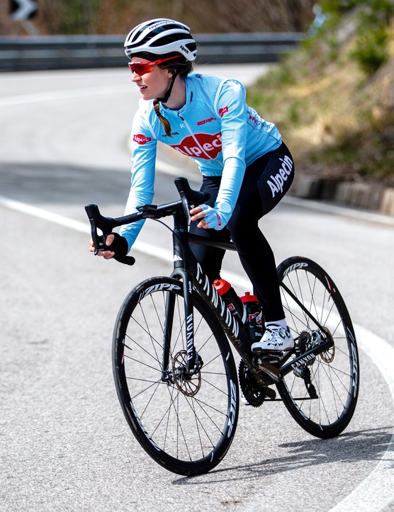 Cycliste féminine faisant du vélo de route en rond et en bas de la colline