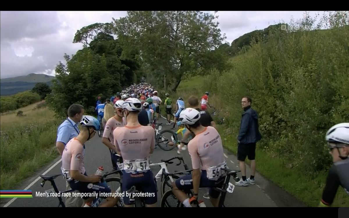 Mathieu van der Poel and the rest of the peloton stopped behind a protest en route to Glasgow
