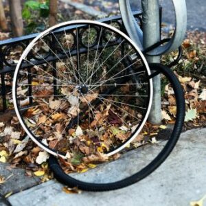 The lone wheel of a stolen bike is still locked to a post, while the tyre lies next to it