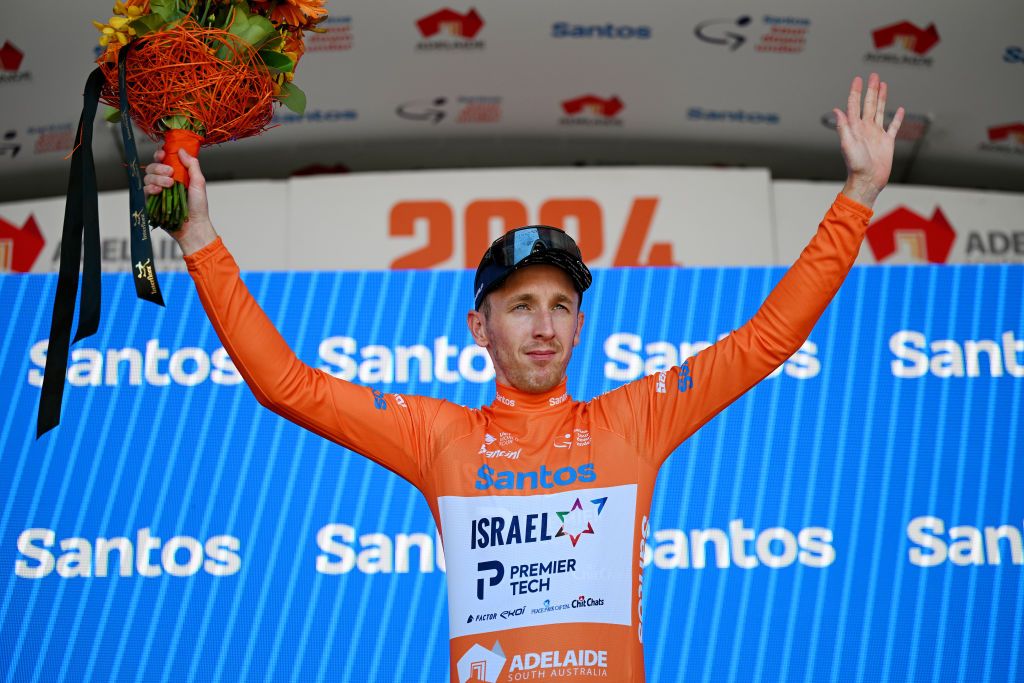 WILLUNGA AUSTRALIA JANUARY 20 Stephen Williams of United Kingdom and Team Israel Premier Tech celebrates at podium as Orange Santos Leaders Jersey winner during the 24th Santos Tour Down Under 2024 Stage 5 a 1293km stage from Christies Beach to Willunga Hill 372m on January 20 2024 in Willunga Hill Australia Photo by Tim de WaeleGetty Images