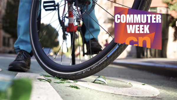 A commuter bike, with Schwalbe tyre, is positioned near some broken glass on a street