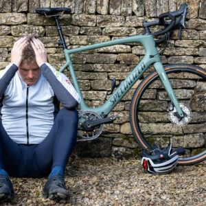 Depressed rider sitting next to e-bike