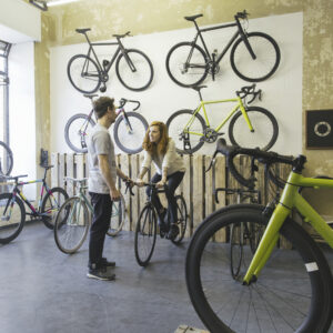 Customer in a bike shop tries a bike for size