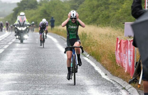 Ruby Isaac wins the junior National Champs in the rain, head in her hands