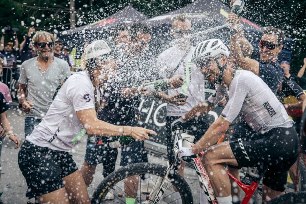 Nino Schurter gets sprayed with champagne in Lenzerheide