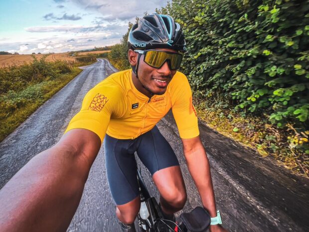 Man takes selfie whilst riding bike on road