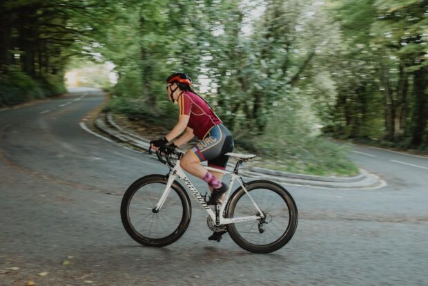 Woman cycles up hill