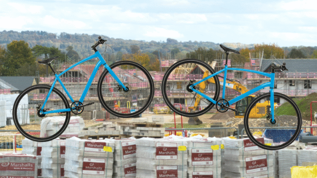 Two bikes layed over a housing development building site