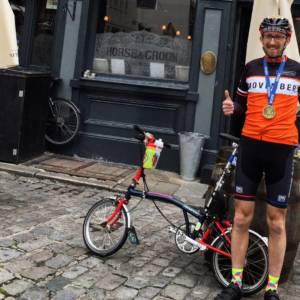 Man stands next to a brompton outside a pub
