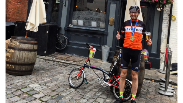Man stands next to a brompton outside a pub