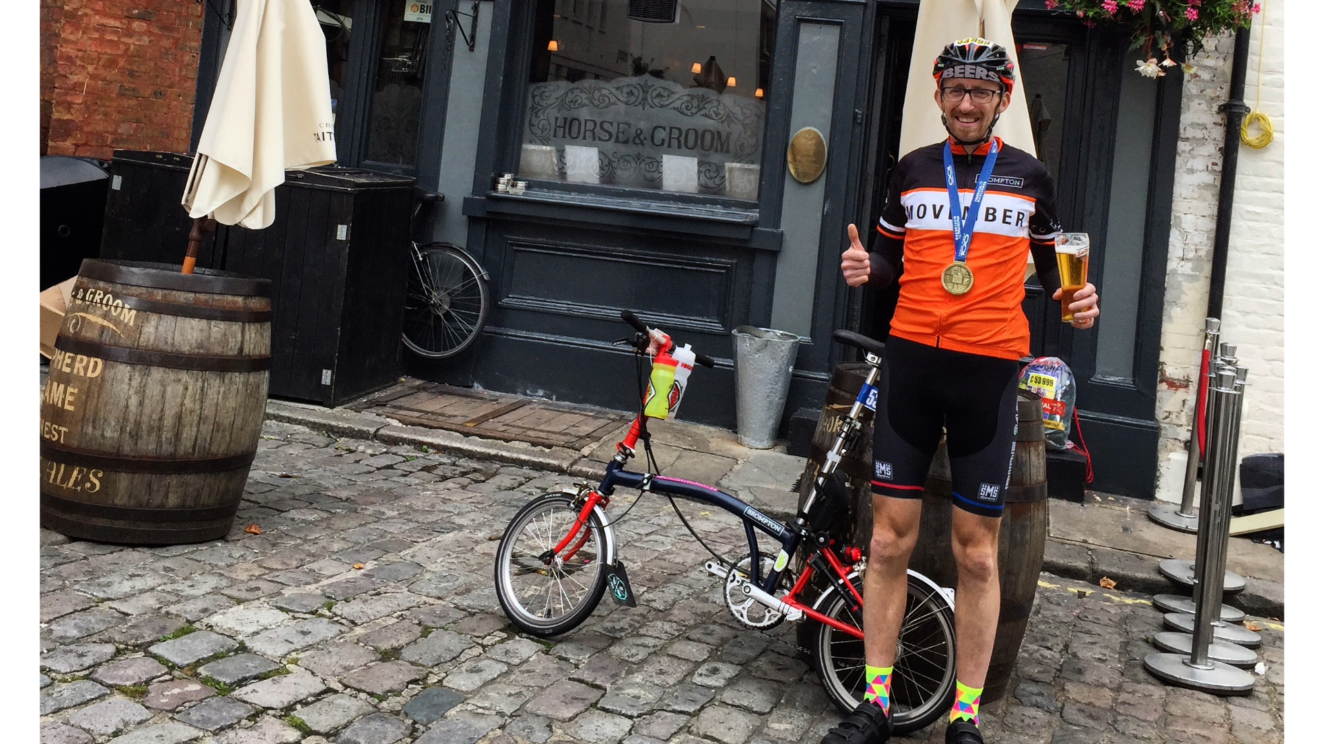 Man stands next to a brompton outside a pub