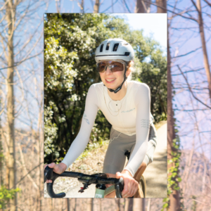 Millie cycles against a woodland background