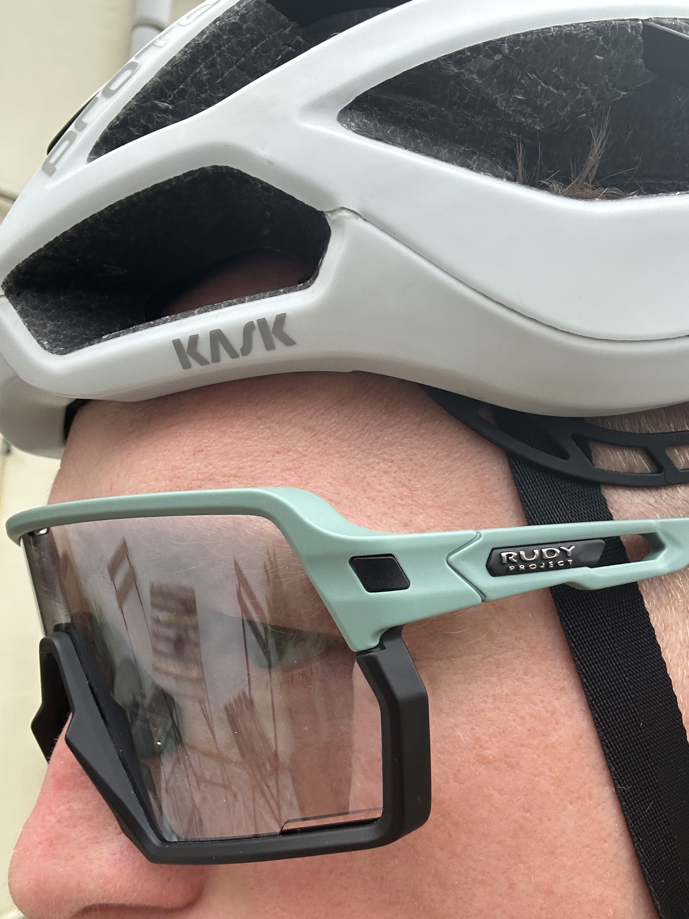 Un homme porte des lunettes de soleil sous un casque de vélo