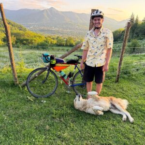 Andrew with his bike, and a new canine friend