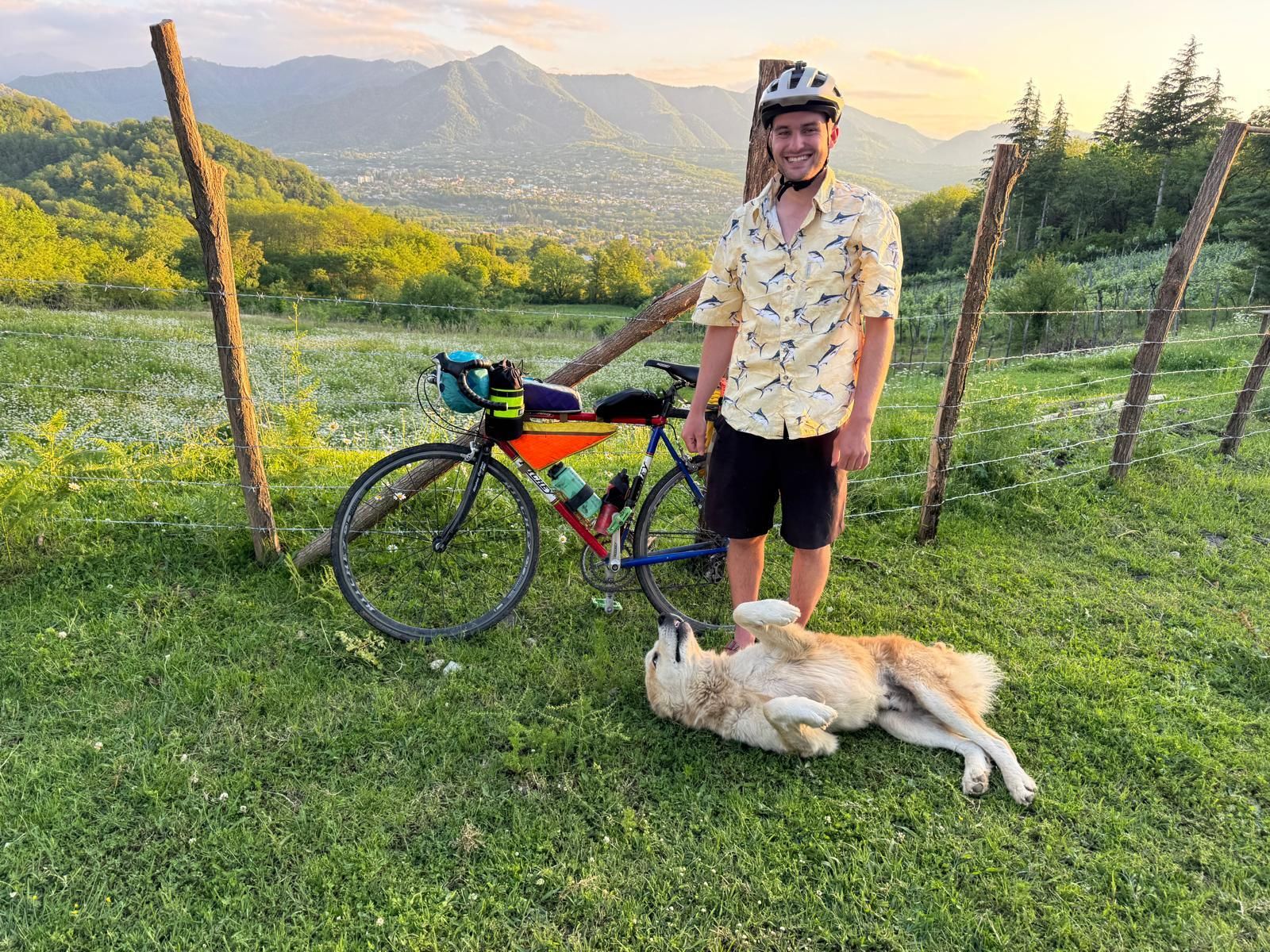 Andrew with his bike, and a new canine friend