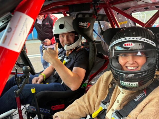 Kim Borthwick with Chris Hoy in a racing car