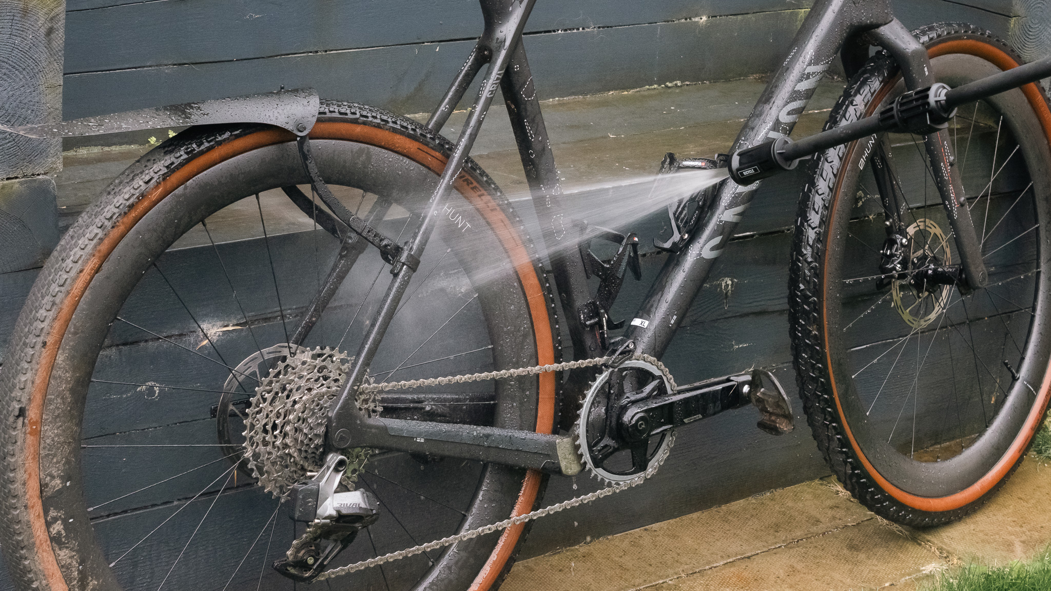 Vue rapprochée de la pulvérisation de lance à pression pour vélo mobile Muc-Off sur un vélo Canyon